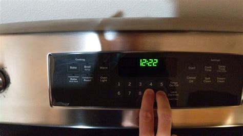 how to set the clock on a ge adora gas stove